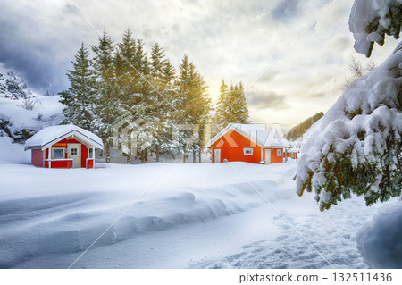 Unbelivable winter scenery with traditional Norwegian red wooden houses on the shore of Rolvsfjord. 132511436