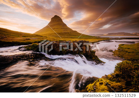 An epic sunset with Kirkjufellsfoss waterfall. Location Iceland, Europe. An epic sunset with Kirkjufellsfoss waterfall. Location Iceland, Europe. 132511529