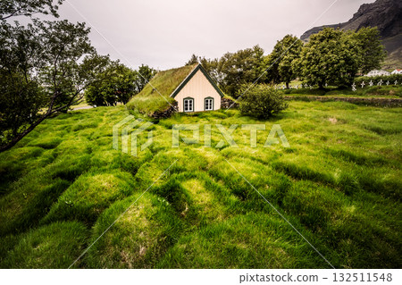 Amazing view of turf church Hofskirkja. Location place of Iceland, small village Hof, Europe. Amazing view of turf church Hofskirkja. Location place of Iceland, small village Hof, Europe. 132511548
