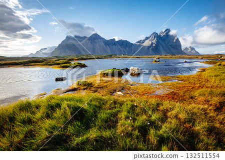 Beautiful mountain landscape on sunny day. Location Stokksnes cape, Vestrahorn, Iceland, Europe. Beautiful mountain landscape on sunny day. Location Stokksnes cape, Vestrahorn, Iceland, Europe. 132511554