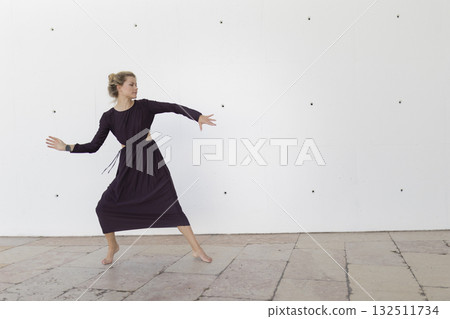 Barefoot woman performing expressive modern dance 132511734