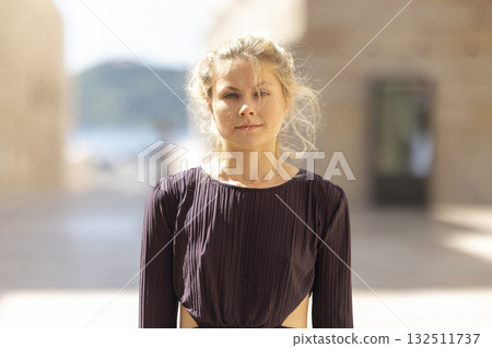 Young woman confidently looking at camera outdoors 132511737