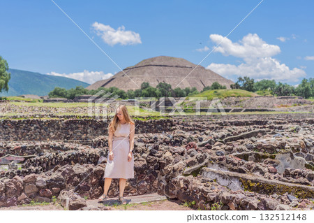 Female tourist standing in front of Teotihuacan pyramids in Mexico, enjoying sightseeing, adventure, and cultural heritage. Travel, tourism, and exploration concept Female tourist standing in front of Teotihuacan pyramids in Mexico, enjoying sightseeing, adventure, and cultural heritage. Travel, tourism, and exploration concept 132512148