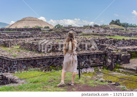 Female tourist standing in front of Teotihuacan pyramids in Mexico, enjoying sightseeing, adventure, and cultural heritage. Travel, tourism, and exploration concept Female tourist standing in front of Teotihuacan pyramids in Mexico, enjoying sightseeing, adventure, and cultural heritage. Travel, tourism, and exploration concept 132512185