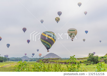 Colorful hot air balloons floating over Teotihuacan in Mexico, creating a breathtaking view of the ancient pyramids. Tourism, adventure, and cultural heritage concept 132512216