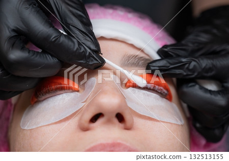 Caucasian woman undergoing eyelash lamination procedure. Caucasian woman undergoing eyelash lamination procedure. 132513155