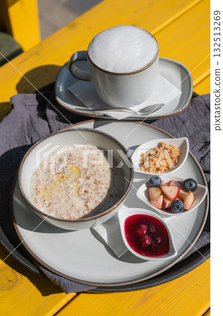 Reserved breakfast at a cafe. A plate of porridge on a table in a street cafe. Reserved breakfast at a cafe. A plate of porridge on a table in a street cafe. 132513269