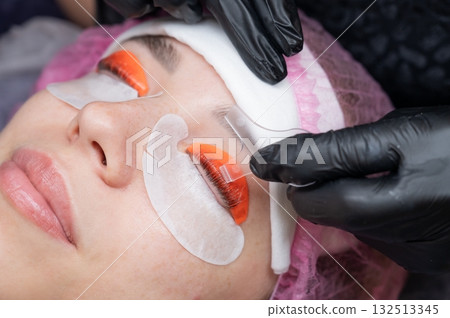 Caucasian woman undergoing eyelash lamination procedure.  132513345