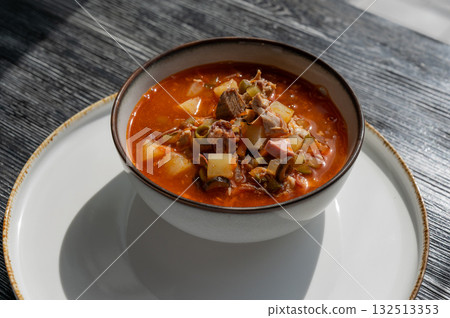 A bowl of solyanka soup in a cafe. A bowl of solyanka soup in a cafe. 132513353