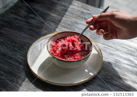A bowl of borscht soup in a cafe. A bowl of borscht soup in a cafe. 132513363