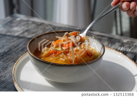 A bowl of shchi soup in a cafe.  132513368
