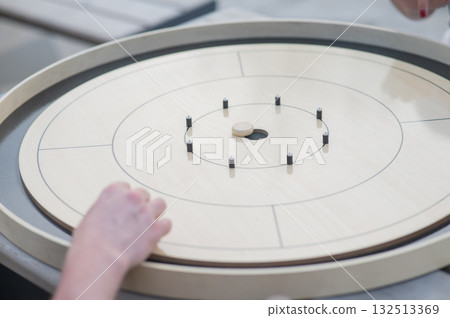 Strategic Game Pieces on a Wooden Board crokinole.  132513369