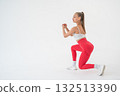 Young woman doing lunges on white cyclorama background. Vertical video.  132513390