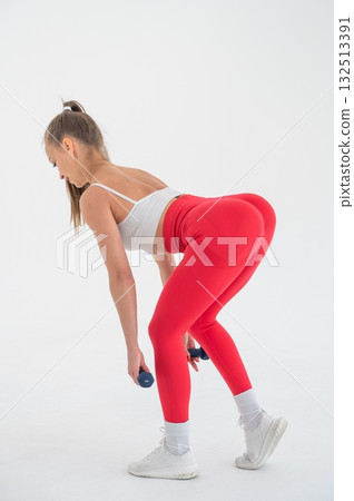 Young woman doing exercise with dumbbells on white background. Young woman doing exercise with dumbbells on white background. 132513391