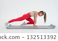 Young woman doing plank exercise on white background. 132513392