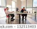 Two Caucasian men working in an office.  132513403