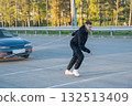 Caucasian man pulling a car with a rope.  132513409