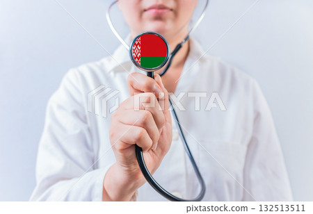 Female doctor holding stethoscope with Belarus flag. National health system of Belarus Female doctor holding stethoscope with Belarus flag. National health system of Belarus 132513511
