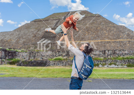 Father with his little toddler son as tourists in front of the pyramids of Teotihuacan in Mexico, enjoying sightseeing, family bonding, and cultural heritage Father with his little toddler son as tourists in front of the pyramids of Teotihuacan in Mexico, enjoying sightseeing, family bonding, and cultural heritage 132513644