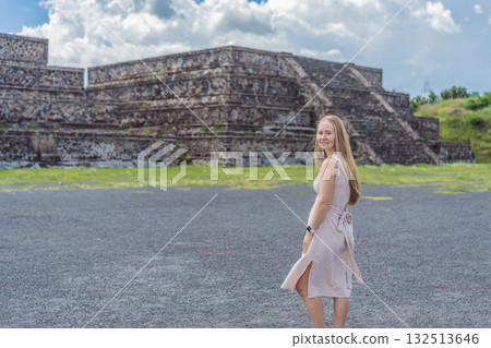 Female tourist standing in front of Teotihuacan pyramids in Mexico, enjoying sightseeing, adventure, and cultural heritage. Travel, tourism, and exploration concept 132513646