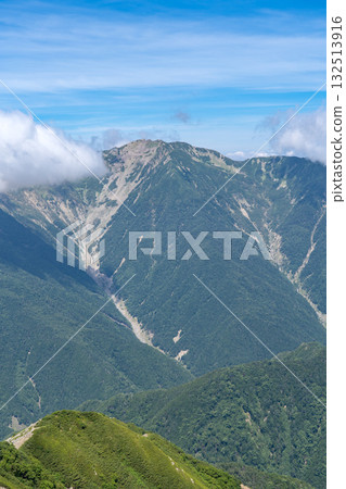 Mount Senjo, the Queen of the Southern Alps, seen from the shoulder of Mount Kita. Climbing Mount Kita in the Southern Alps. Mount Senjo, the Queen of the Southern Alps, seen from the shoulder of Mount Kita. Climbing Mount Kita in the Southern Alps. 132513916