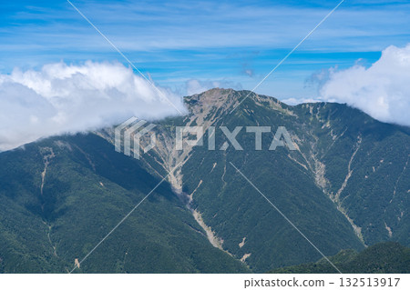 Mount Senjo, the Queen of the Southern Alps, seen from the shoulder of Mount Kita. Climbing Mount Kita in the Southern Alps. Mount Senjo, the Queen of the Southern Alps, seen from the shoulder of Mount Kita. Climbing Mount Kita in the Southern Alps. 132513917