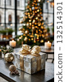 Luxury gift box with gold ribbon in cozy holiday room decor featuring christmas tree and festive lights 132514301