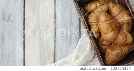 Fresh crispy croissants and a cup of fragrant tea. Breakfast. Morning. customs and culture. Start of the day. Fresh crispy croissants and a cup of fragrant tea. Breakfast. Morning. customs and culture. Start of the day. 132514354