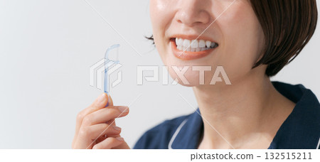 Young woman using dental floss 132515211