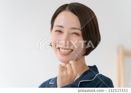 Young woman using dental floss Young woman using dental floss 132515352