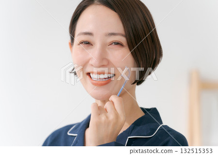 Young woman using dental floss Young woman using dental floss 132515353