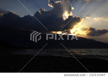 Sunset over Turkish beach with dark clouds Sunset over Turkish beach with dark clouds 132515447