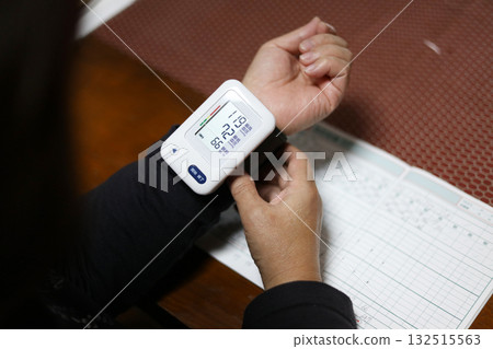A woman measuring blood pressure A woman measuring blood pressure 132515563