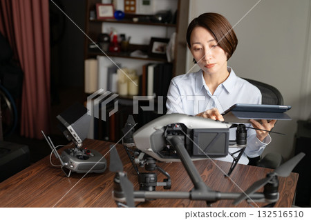 A woman maintaining a drone 132516510