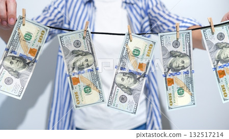 Financial Misconduct Monetary Bills Drying on a Line, Symbolizing Illegal Practices 132517214