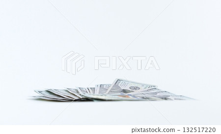 Pile of Hundred Dollar Bills on White Surface, Symbolizing Wealth and Financial Success Pile of Hundred Dollar Bills on White Surface, Symbolizing Wealth and Financial Success 132517220