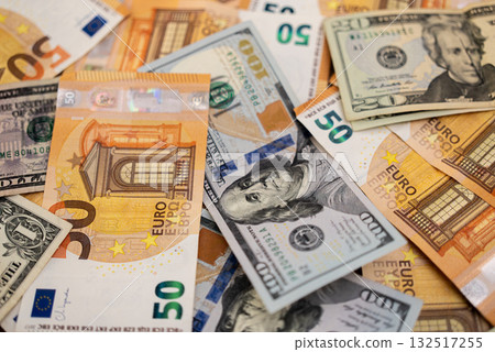 Assortment of Euro and US dollar banknotes spread out. Represents currency exchange and international financial markets Assortment of Euro and US dollar banknotes spread out. Represents currency exchange and international financial markets 132517255