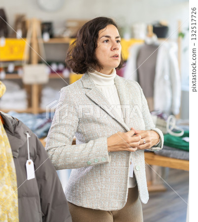 Latin American woman is fitting on and trying on blazer in store 132517726