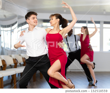 Young guy and adult woman dance tango 132518559