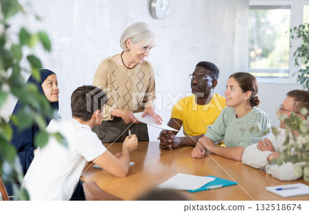 Elderly female tutor conducting foreign language speaking club Elderly female tutor conducting foreign language speaking club 132518674