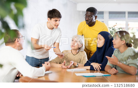 Interested guy discussing study topics with group of coursemates Interested guy discussing study topics with group of coursemates 132518680