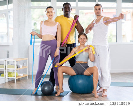 Multiethnic group of cheerful sporty people with fitness equipment in studio Multiethnic group of cheerful sporty people with fitness equipment in studio 132518939