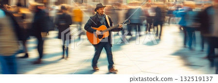 Country musician playing acoustic guitar and singing in a crowded city center with blurred people walking by, creating a sense of motion and urban atmosphere 132519137