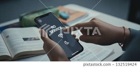 Student hands holding smartphone showing no service with wi fi and mobile data icons, conveying network outage, connectivity issues and frustration while trying to access internet Student hands holding smartphone showing no service with wi fi and mobile data icons, conveying network outage, connectivity issues and frustration while trying to access internet 132519424