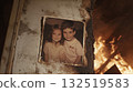 Parents and children baking pizza over a bonfire 132519583
