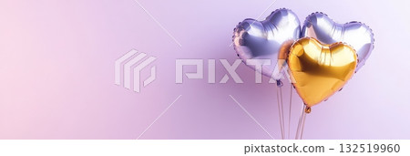 Floating on a pastel purple background, two silver and one golden heart shaped balloon create a romantic and festive atmosphere for celebrations like valentine's day and anniversaries 132519960