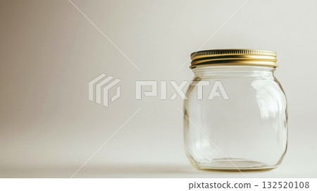empty glass jar with gold lid on white background 132520108
