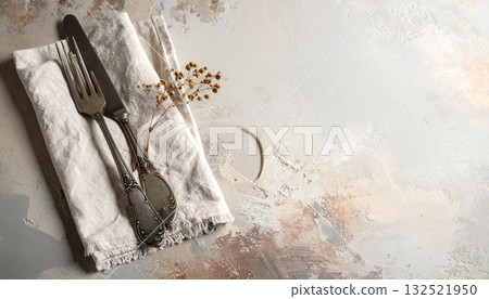 Antique fork and knife on a linen napkin Antique fork and knife on a linen napkin 132521950