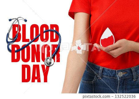 Person in red holds a blood droplet and shows a bandage Person in red holds a blood droplet and shows a bandage 132522036