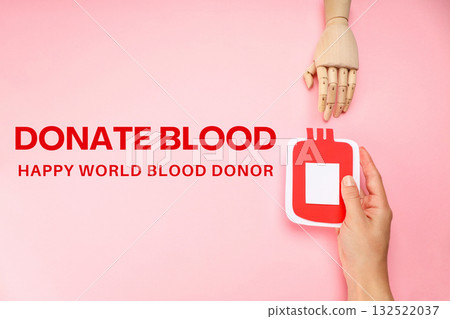 A hand holding a blood donation symbol points to a model hand 132522037